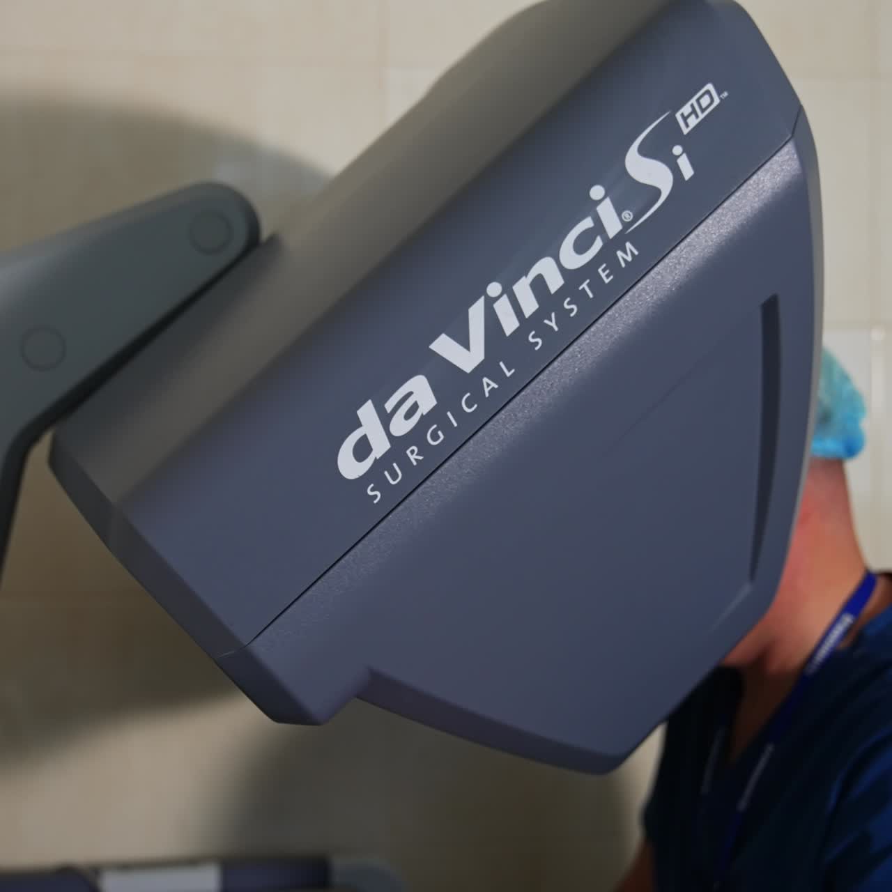 Da Vinci robot console with doctor sitting at it. Innovative equipment for modern high-precise surgeries in clinics