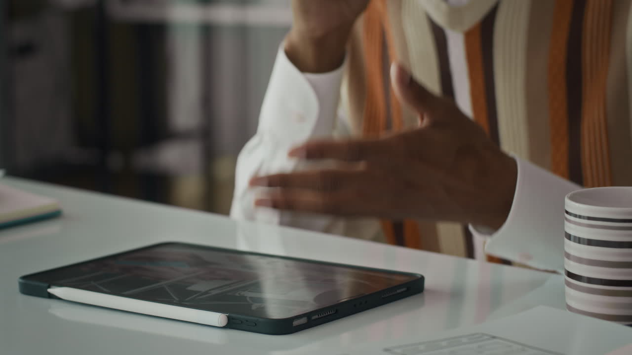 Male Employee Confirming Details of Meeting on Cellphone at Office Desk