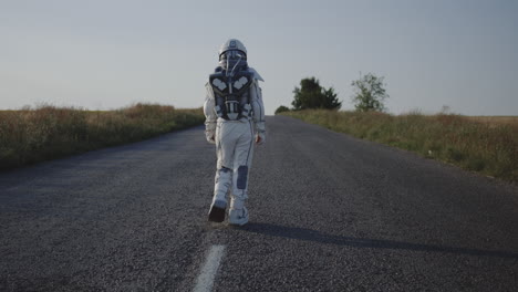 child in spacesuit walking down a road