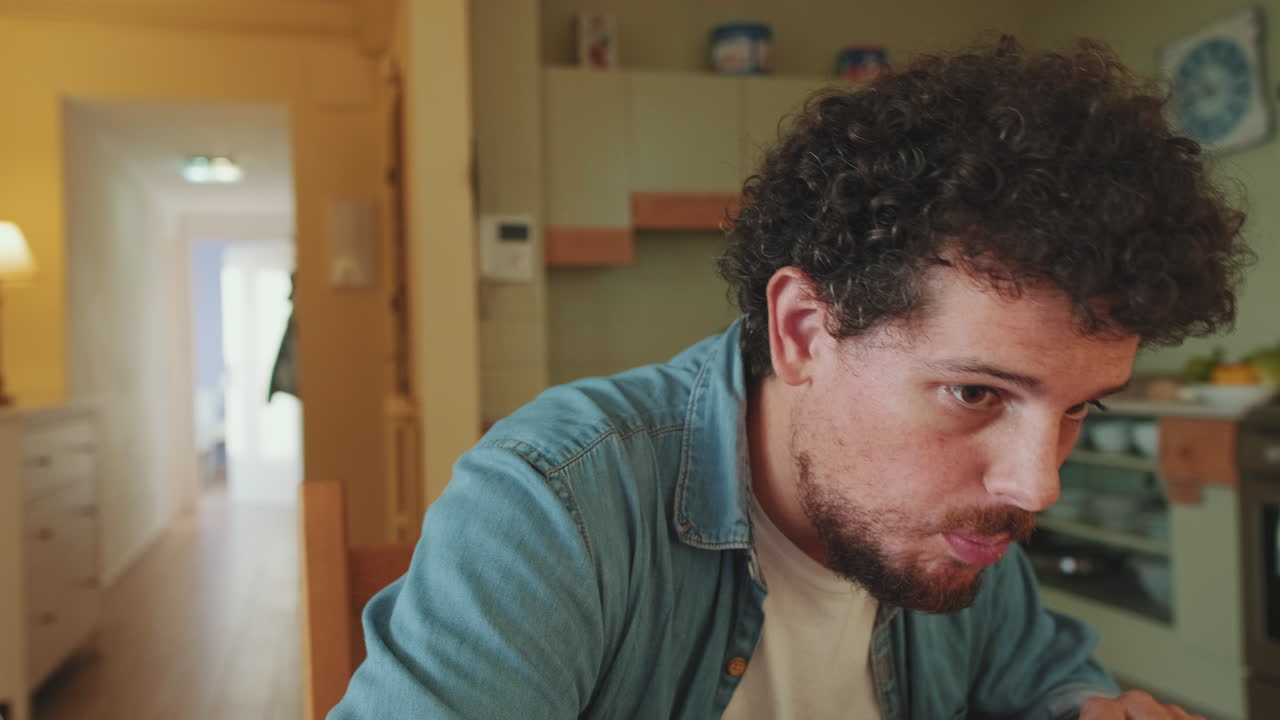 Man Eating a Sandwich at Home