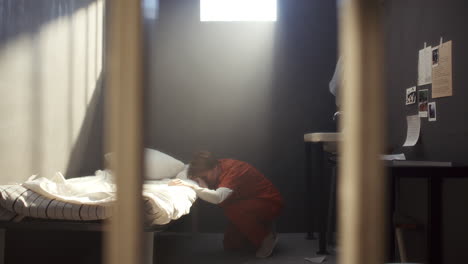 furious female inmate screaming and swinging arm through prison bars in rage