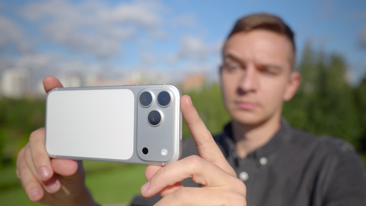 Man takes selfies outdoors