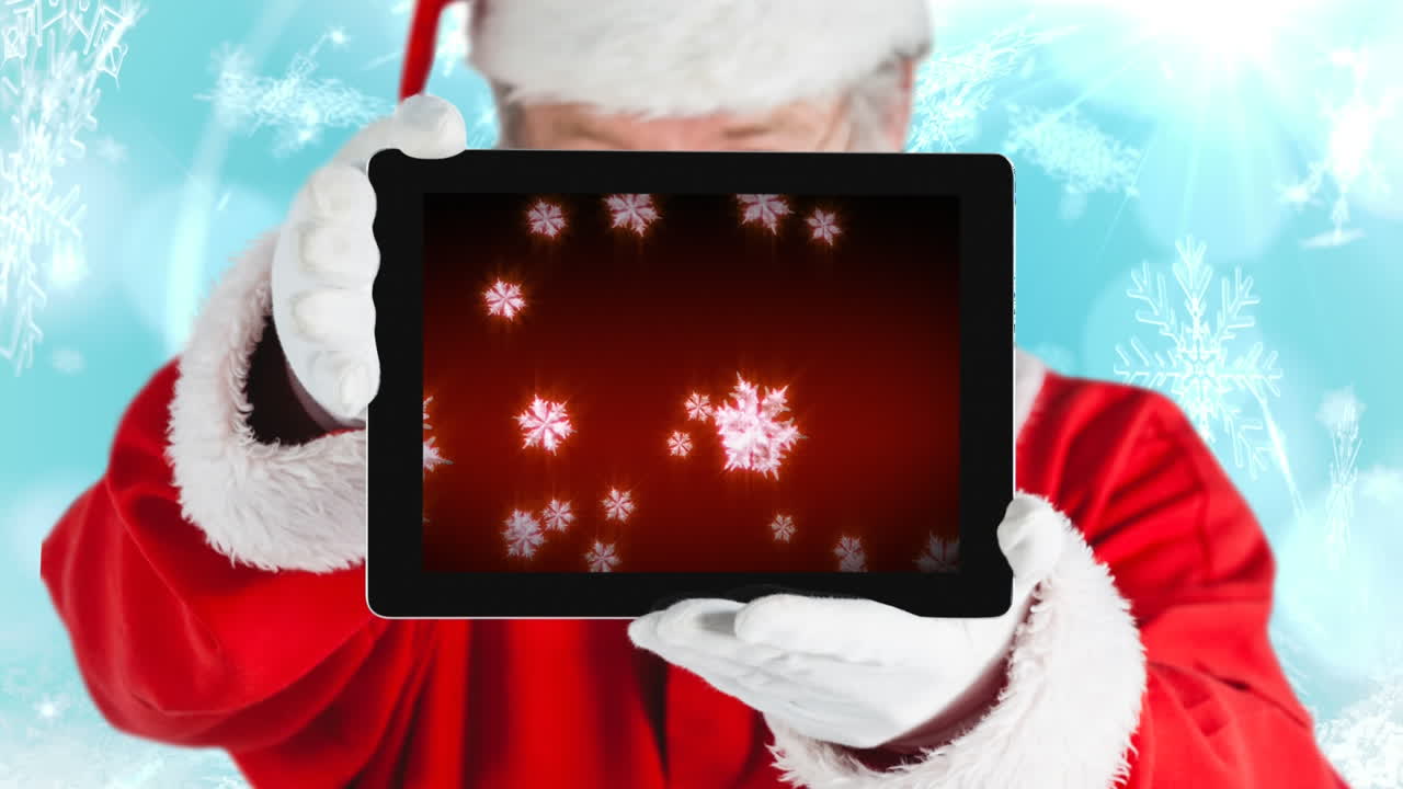스노우플레이크를 가진 태블릿을 사용하는 산타