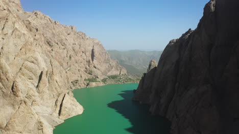 Slow-epic-cinematic-drone-shot-over-top-the-Kel-Suu-lake-and-inside-its-ravine-in-Kyrgyzstan