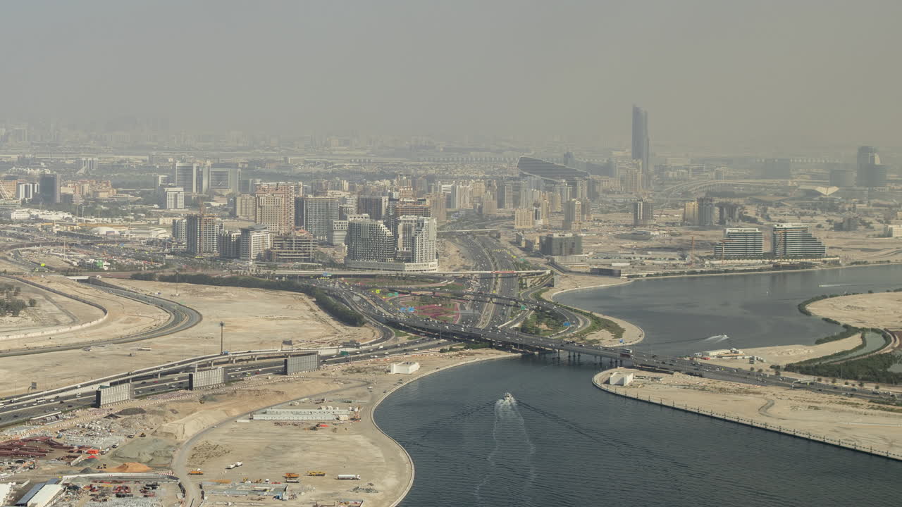 Hazy Aerial View of Dubai City with River and Highways