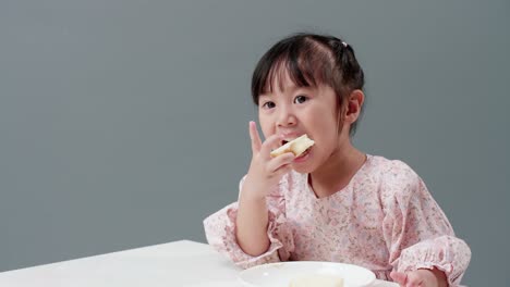 happy asian girl smile and enjoy eaing crispy butter toast at home