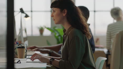 young business woman typing using computer successful entrepreneur busy on company project dedicated female in  busy office workspace