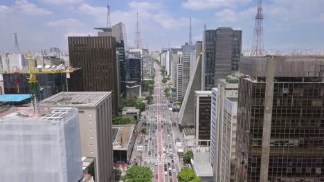 aerial footage of a busy street avenida paulista in sao paulo, brazil- sunny summer day full of people and cars