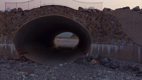 Dry-creek-with-large-pipe-reveals-mountains