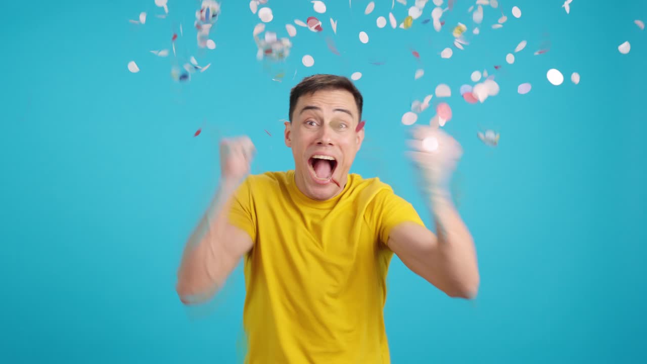 Excited man celebrating with confetti