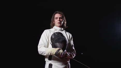 fencer in white uniform with foil sword