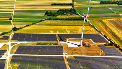 fields with solar panels and wind turbines. energy concept. productions of green energy. aerial view
