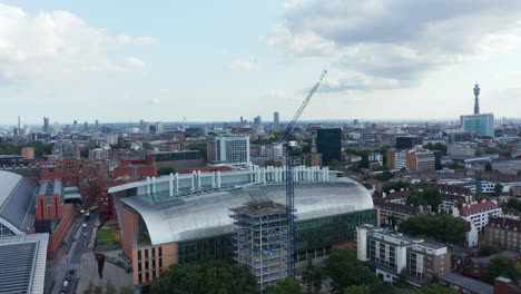 Orbit-shot-around-tower-crane-on-construction-site.-Modern-building-of-Francis-Crick-Institute.-London,-UK