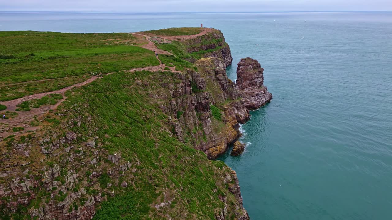 Forward drone movement to the Cap Fréhel peninsula rocky lookout and endpoint, Côtes-d'Armor, Brittany, France.