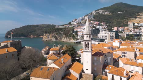 Drohne-Fliegt-Am-Uhrturm-Vorbei-Und-Enthüllt-Wunderschöne-Strände-In-Budva,-Montenegro