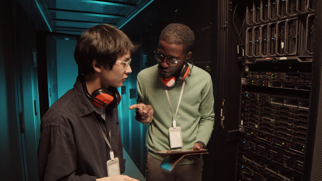 Two IT Engineers Talking in Server Room