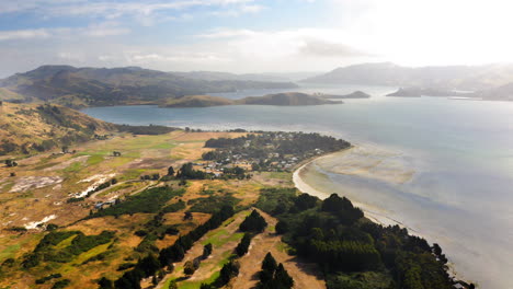 aerial view of a coastal landscape with a bay, town, and hills