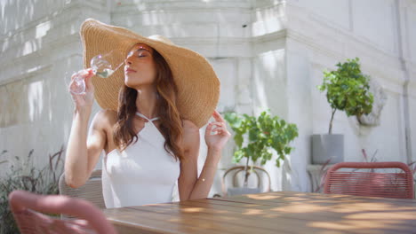 luxurious woman enjoy wine in glass goblet at open space restaurant closeup