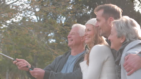 composite image of portrait of caucasian family showing thumbs up against flower fields