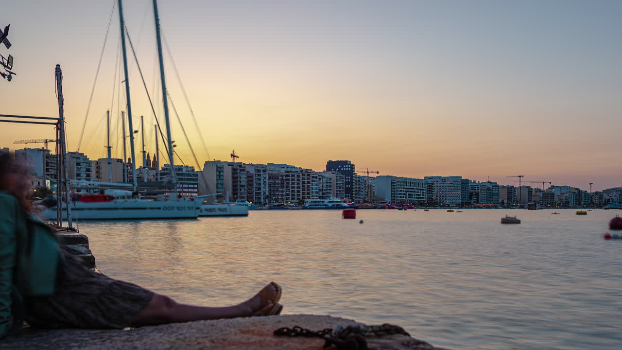 해가 지는 풍경과 항구에 앉아 바다를 둘러보는 여자의 타임 스