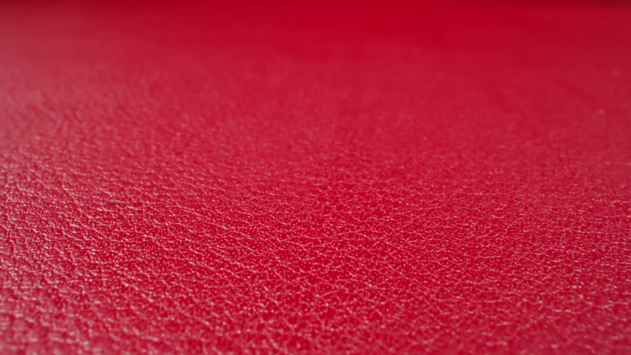 Abstract pattern of wrinkles on red cow leather surface