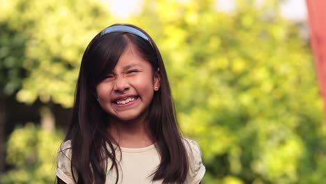 8 year old latina girl making funny face and smiling