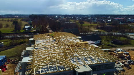 aerial view circling a wooden roof frame construction of a suburban condo