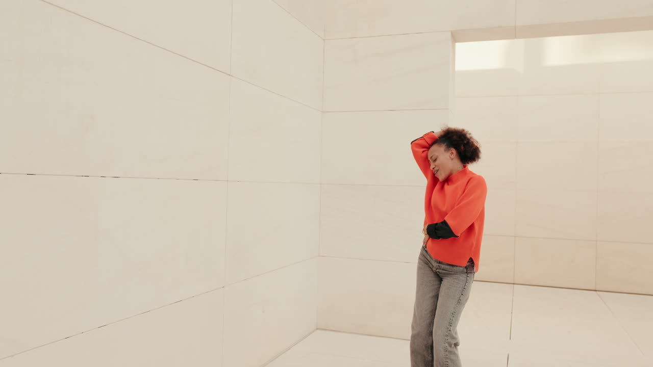 Young Woman Dances Joyfully in a Minimal Room