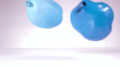 two blue water balloon falling