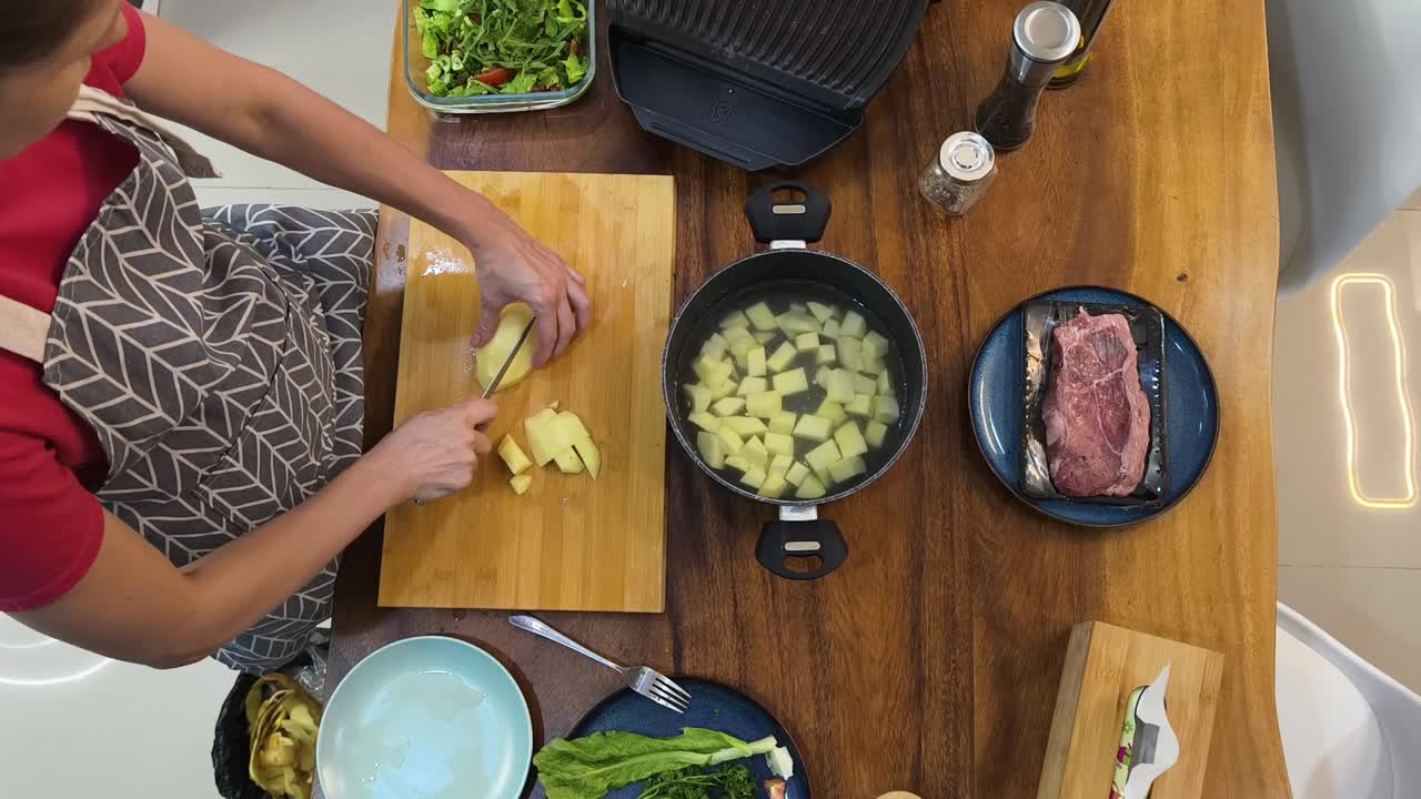 Preparing potatoes and steak
