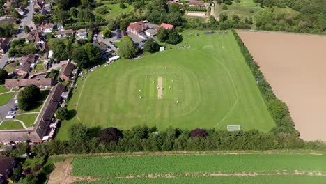 4k drone video of a sunny village cricket match in kent, england