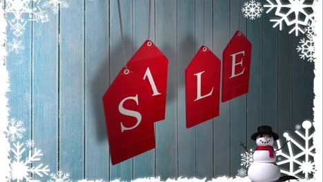 red sale tags hanging against wood with festive border