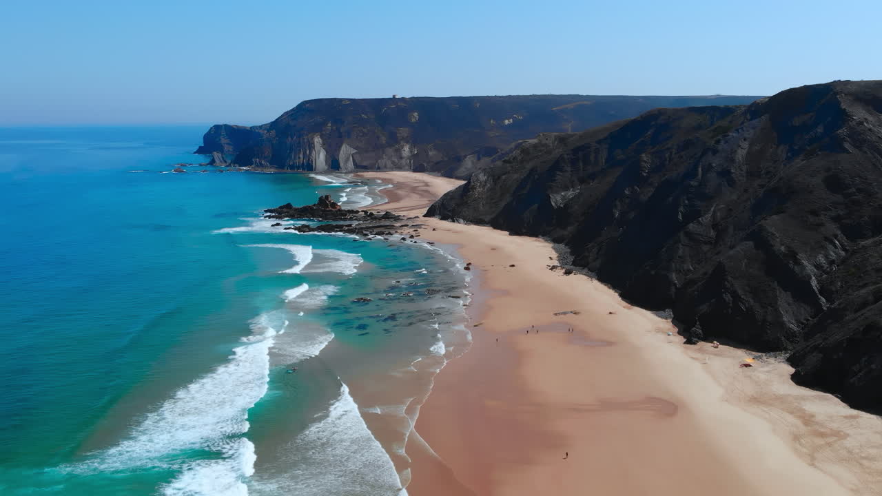 Aerial View of a Stunning Beach with Cliffs and Turquoise Water