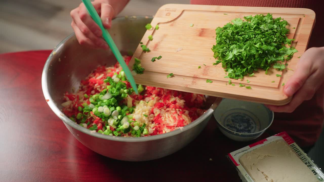 Adding green onion and cilantro to vegetable filling
