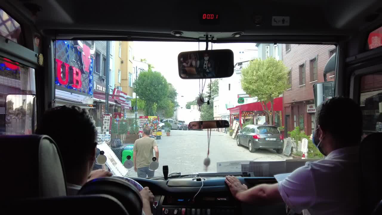 View from the front of a tour bus in Istanbul, Turkey, showcasing the dynamic city streets offering a unique perspective of the bustling urban environment and rich cultural heritage.