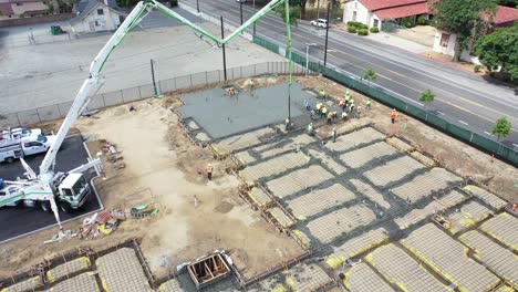 Remarkable-Aerial-Over-Construction-Site-With-Giant-Crane-And-Workers-Pouring-Concrete-Foundation-In-Ventura-California-1