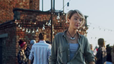 Beautiful-Young-Blonde-Woman-With-Short-Blond-Hair-Smiling-And-Looking-To-The-Camera-While-Being-Outdoor-At-The-Party