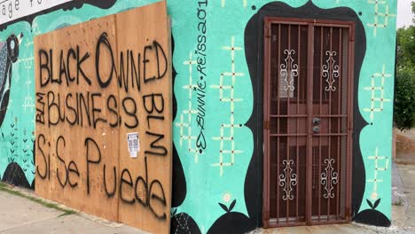 a boarded up los angeles storefront is identified as a black owned business during rioting and looting black lives matter protests  1