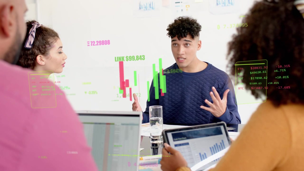 Speaker starting, gesturing and animating candles while woman tapping tablet explaining finance