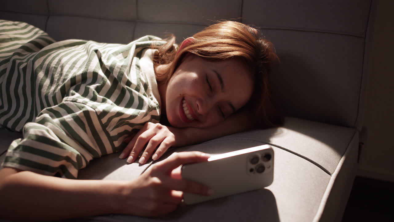 Woman Sleeping on Couch with Phone