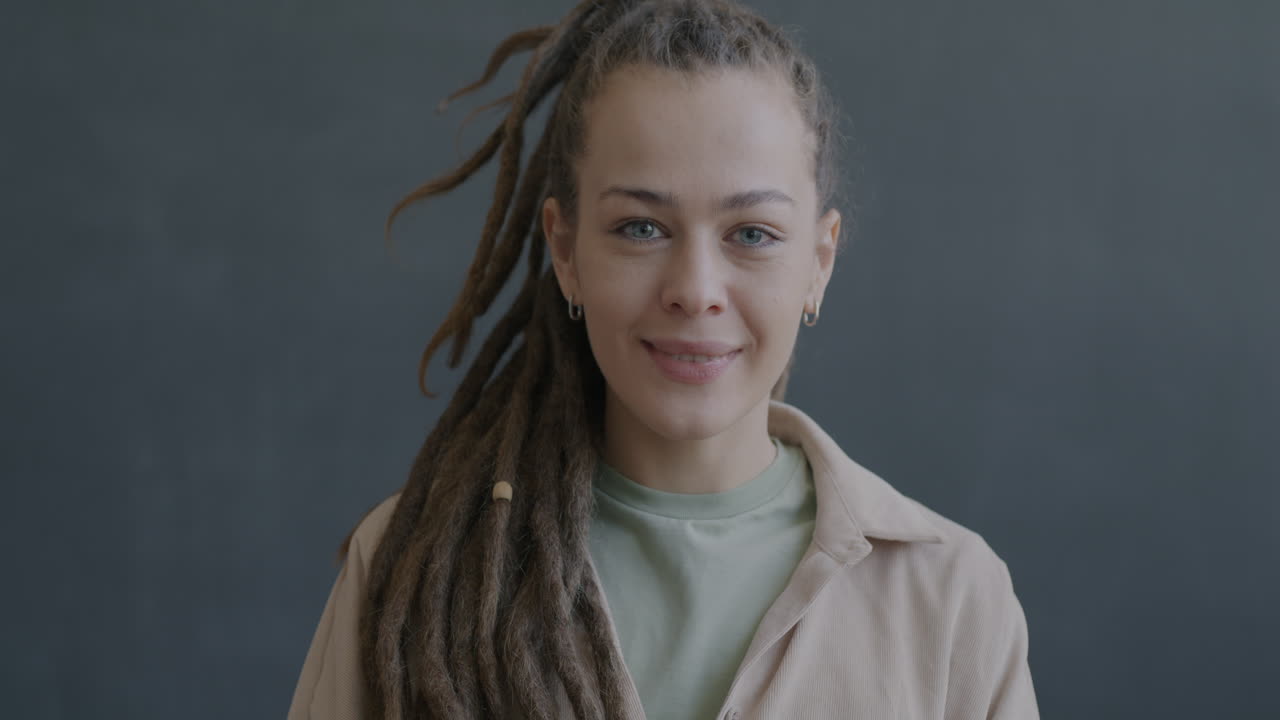 Woman with Dreadlocks Smiling and Waving