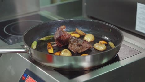 cooking beef and vegetables in a pan