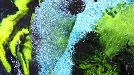 abstract texture of glittering blue and green liquid in motion, macro mixing view