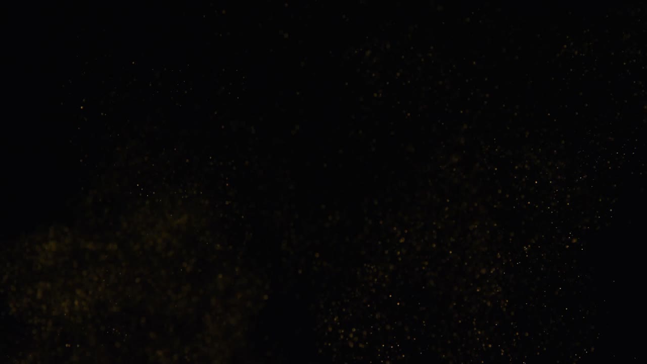 Close-up of glitter falling diagonally 4k