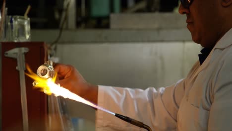 vista lateral de un trabajador masculino que crea vidrio en una fábrica de vidrio 4k