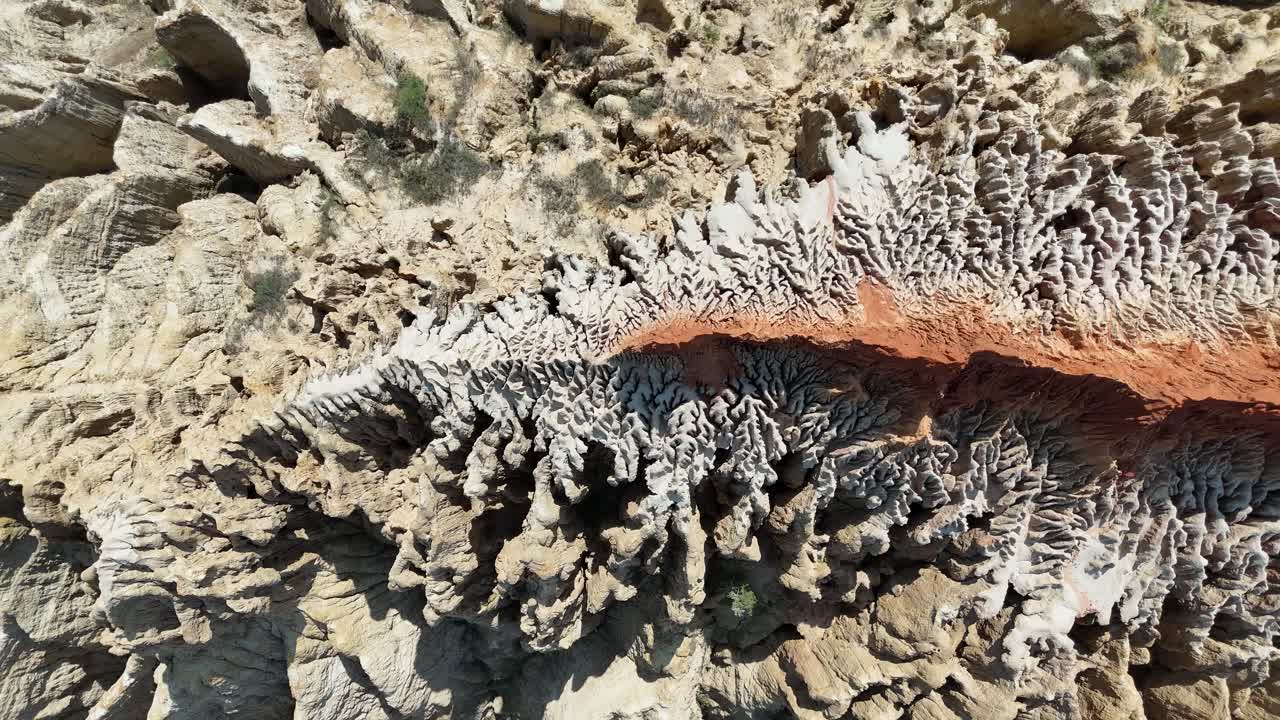 Luftfoto med drone af de indviklede erosionsmønstre og klare orange farver ved Miradouro da Lua-klipperne i Angola – et rejsemål i Afrika