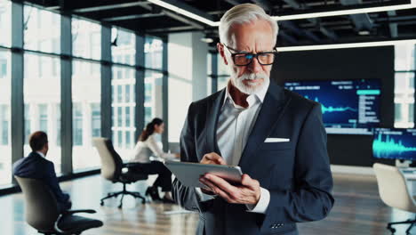 senior business executive using tablet in modern office environment