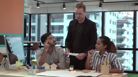 Creative-business-people-group-having-conversation-at-office-desk-in-workplace.