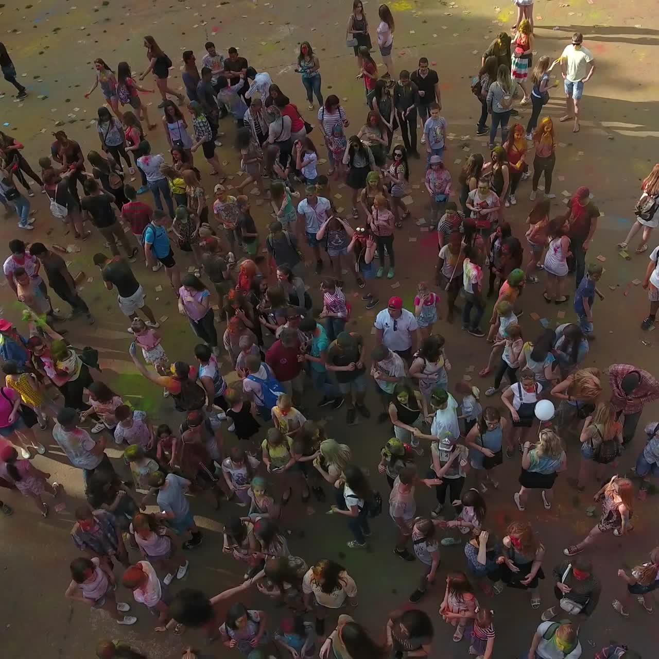 People Celebrating Festival Of Colors. VINNITSA, UKRAINE - JULY 2017: Young people at holi party covered with color powder