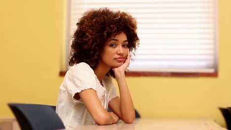 Bored-student-looking-at-the-camera-in-classroom